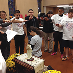 Vision 2016 Parra 5 The paths of prayer Parra kneels to receive a blessing before she runs a marathon.