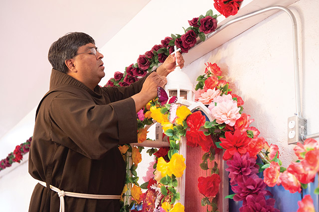 Vision 2021 Schuck Scheiber 7 A day in the life of a Franciscan missionary Father Ponchie Vásquez, O.F.M. repairs the cross on top of Our Lady of Lourdes Shrine in the village of Comobabi, Arizona.