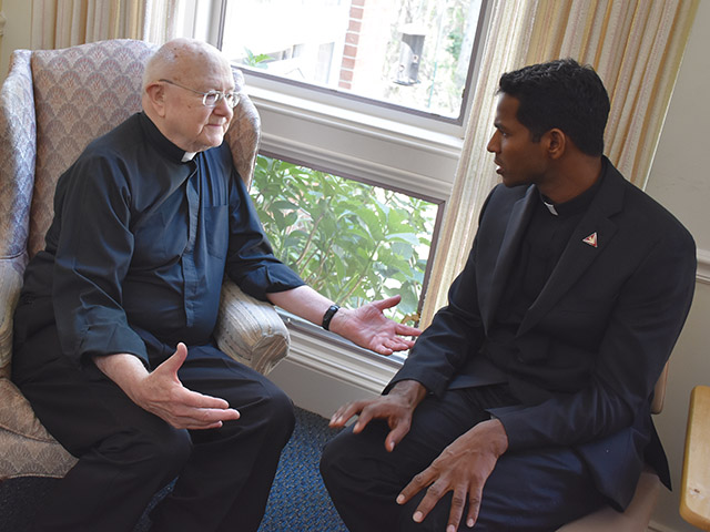 Vision 2023 Romero 3 Community life: A place to call home Father Edwin Dill, S.T. (left) and Father Aro Varnabas, S.T., members of the Missionary Servants of the Most Holy Trinity, sit and chat.