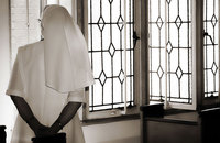 Nun gazing out window