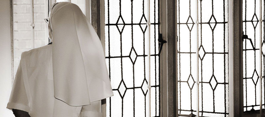 Nun gazing out window