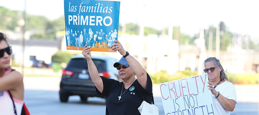 Sister Joni Luna, S.P. (left) takes part in a demonstration of solidarity with migrants, immigrants, and refugees.